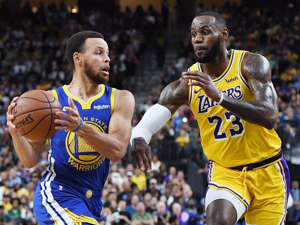 LeBron James and Stephen Curry battle it out in a NBA match